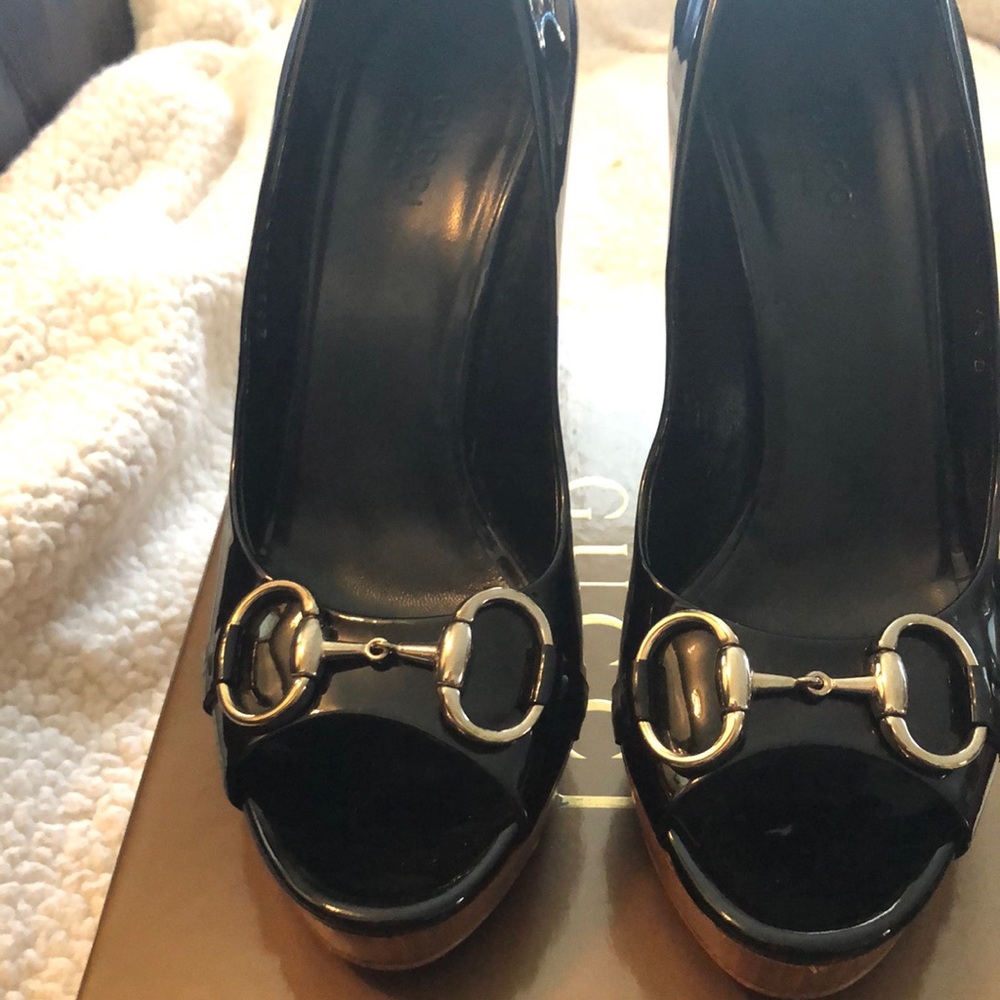Gucci black-patent “horse-bit” peep toe stilettos.